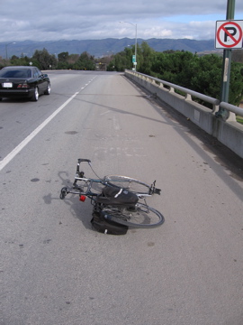 "Bike Lane" (painted on shoulder, now faded). CVC 21966 allows walkers in bike lanes if adjacent sidewalks are lacking. (top of bridge, south side, eastbound)