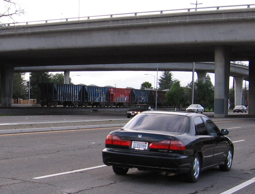 Freight train and car traffic. Grade separations are the safest form of crossing, bar none. (photo: Blossom Hill bridge, looking N)