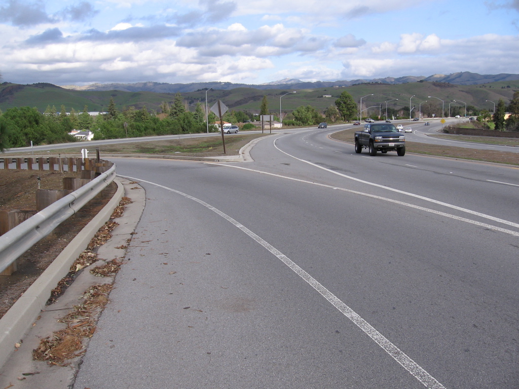 Where on-ramp reaches top, continue with straight-through walking facility. (NE side)