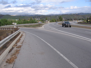 Where on-ramp reaches top, continue with straight-through walking facility. (NE side)